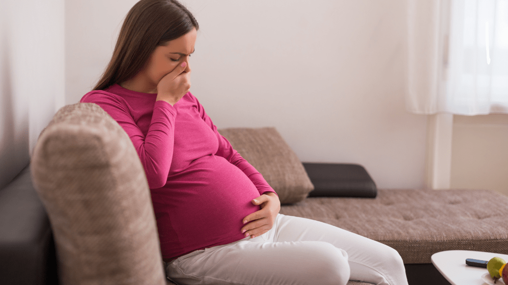 A Pregnant woman sitting on a couch