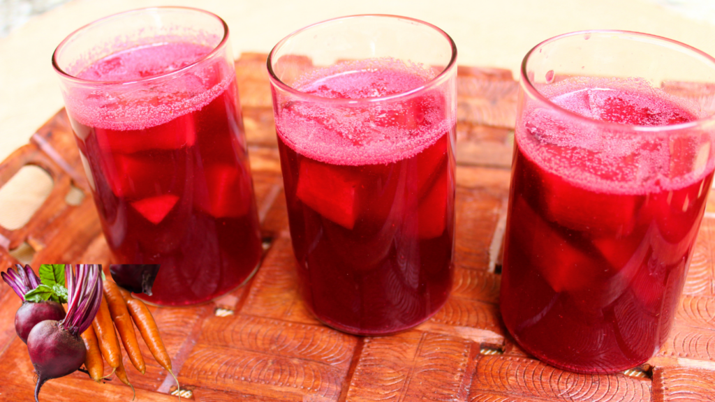 beetroot kanji is kept on a rustic table in glass.